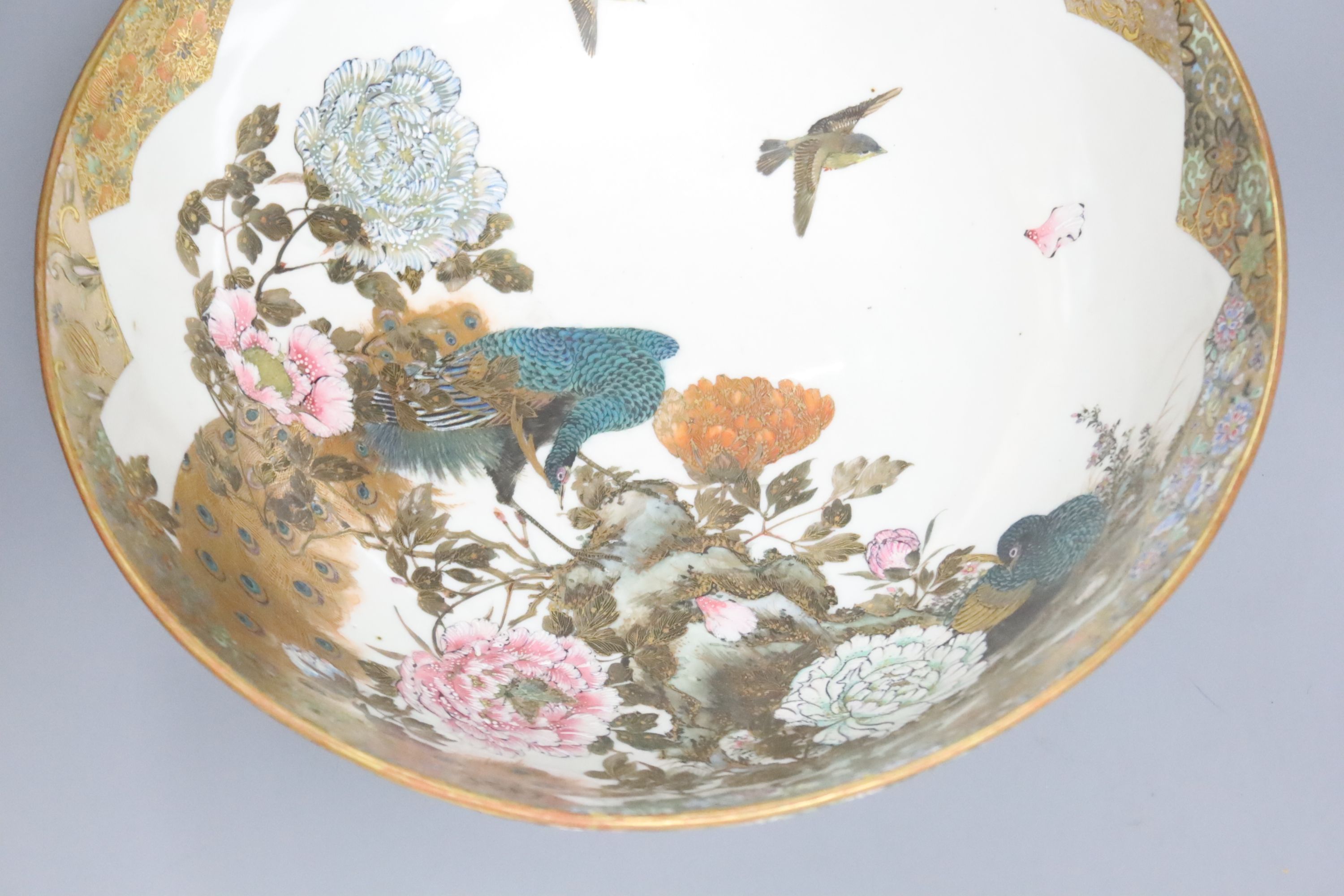 A large early 20th century Japanese Kutani bowl, painted with peacocks and flowers, 13cm high, 31cm diam